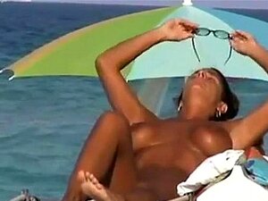 Busty MILF Tanning At Nude Beach